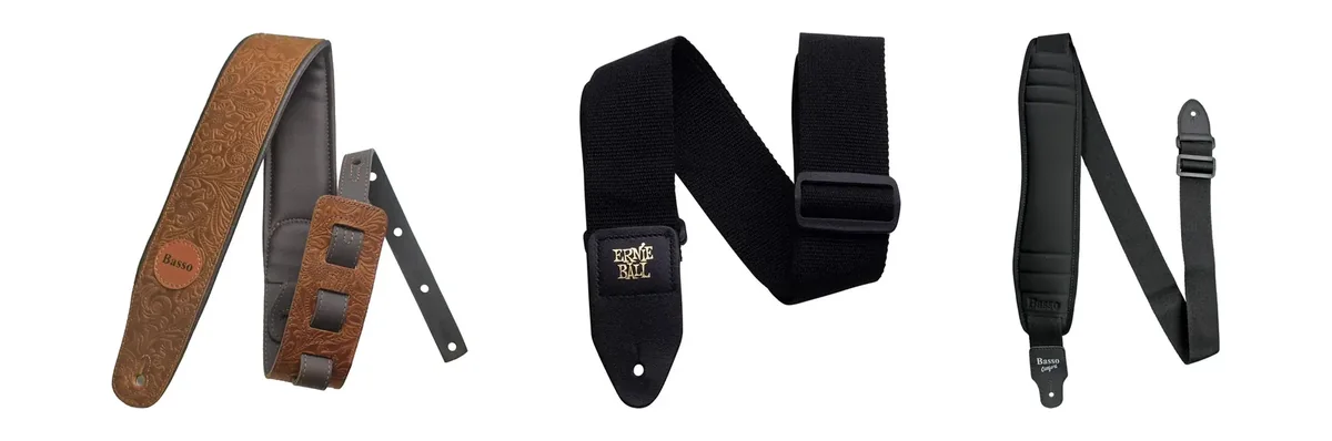 Três correias de guitarra lado a lado em fundo branco: couro marrom com relevo, polipropileno preto Ernie Ball e neoprene acolchoado