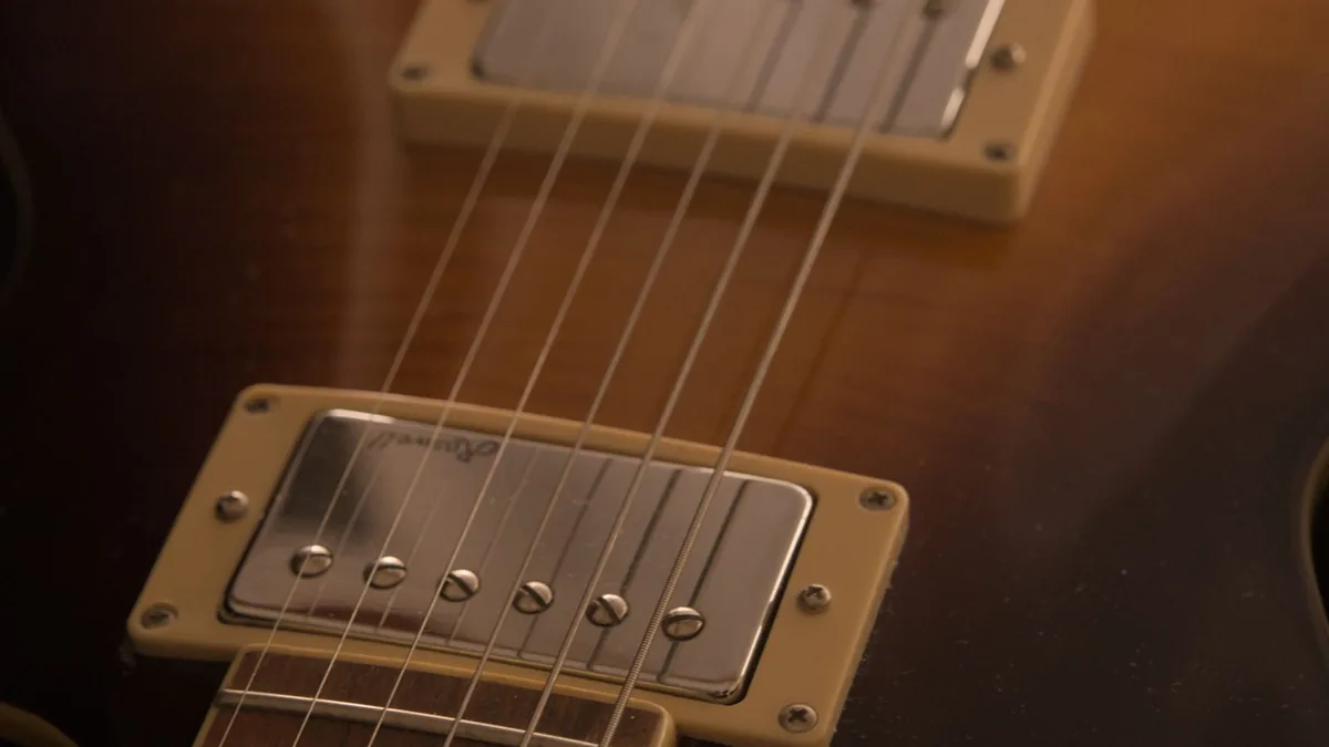 dois captadores humbucker com capa cromada e anel creme numa guitarra sunburst